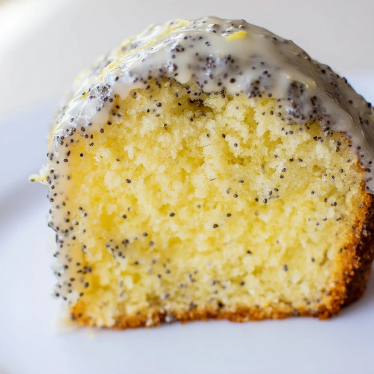 A basket of freshly baked Lemon Poppy Seed Muffins, dusted with poppy seeds and filled with bright lemon zest.