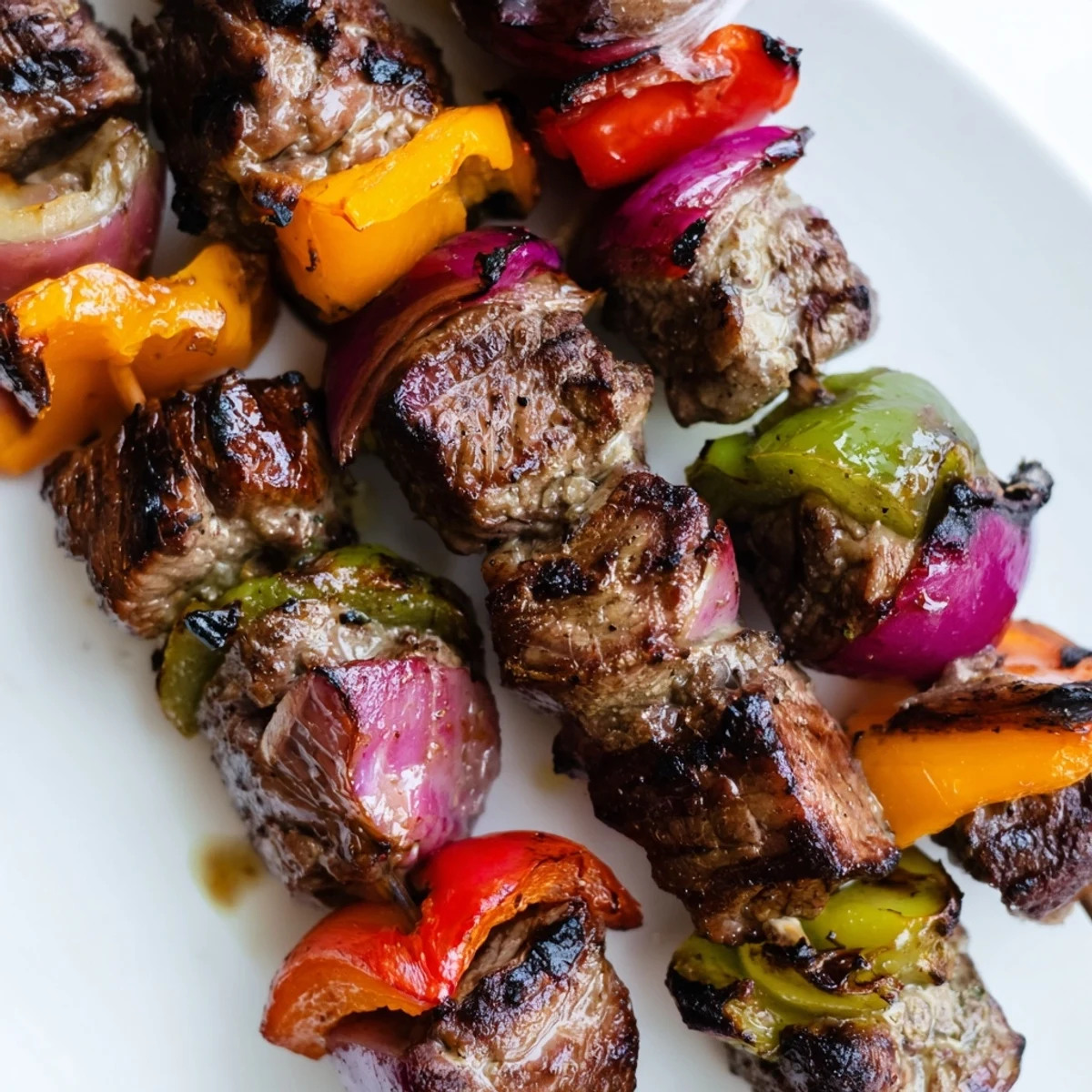 Grilled beef kebabs with bell peppers and red onion served over rice for a weeknight dinner.