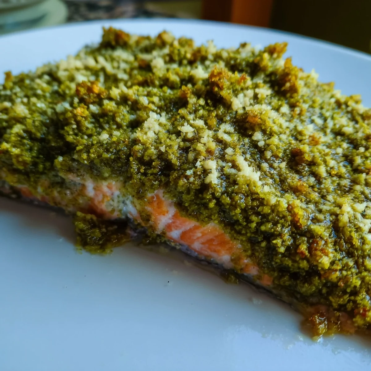 Flaky, perfectly cooked Baked Salmon with Pesto Crust, featuring a vibrant herb topping and a squeeze of fresh lemon, ready to serve.