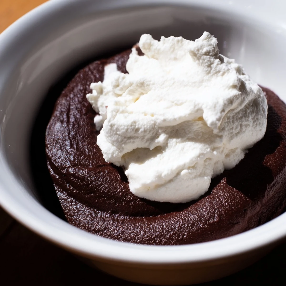 Four elegant servings of Chocolate Mousse with Whipped Cream, featuring a silky texture and fresh berry topping.