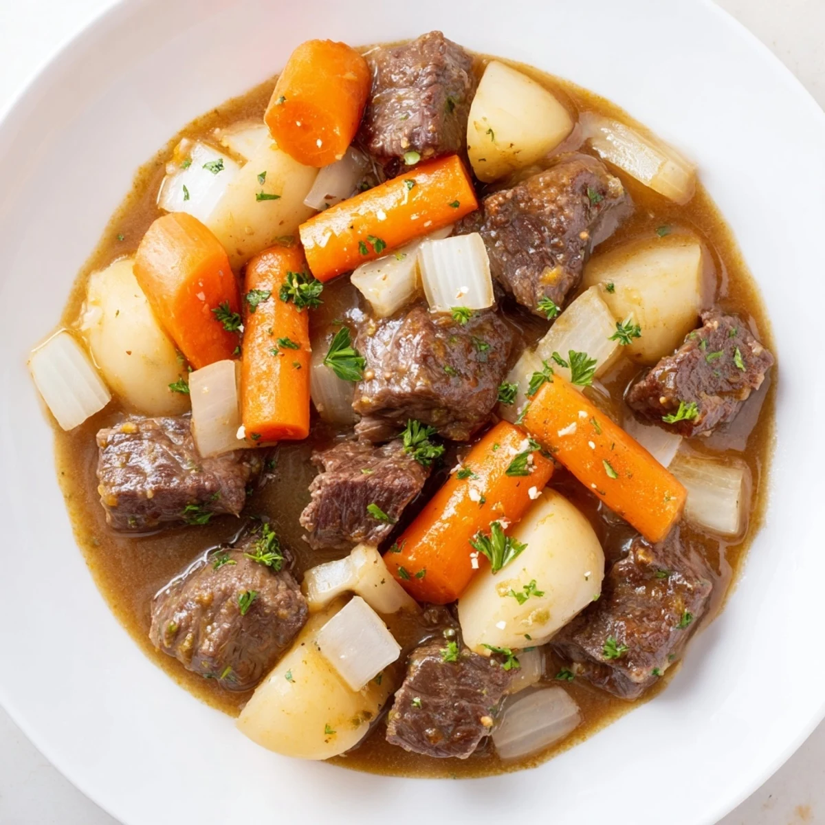 Comforting Savory Beef Stew with Root Vegetables in a Dutch oven, showcasing carrots, potatoes, and parsnips simmering in a thick, red-wine-infused broth.