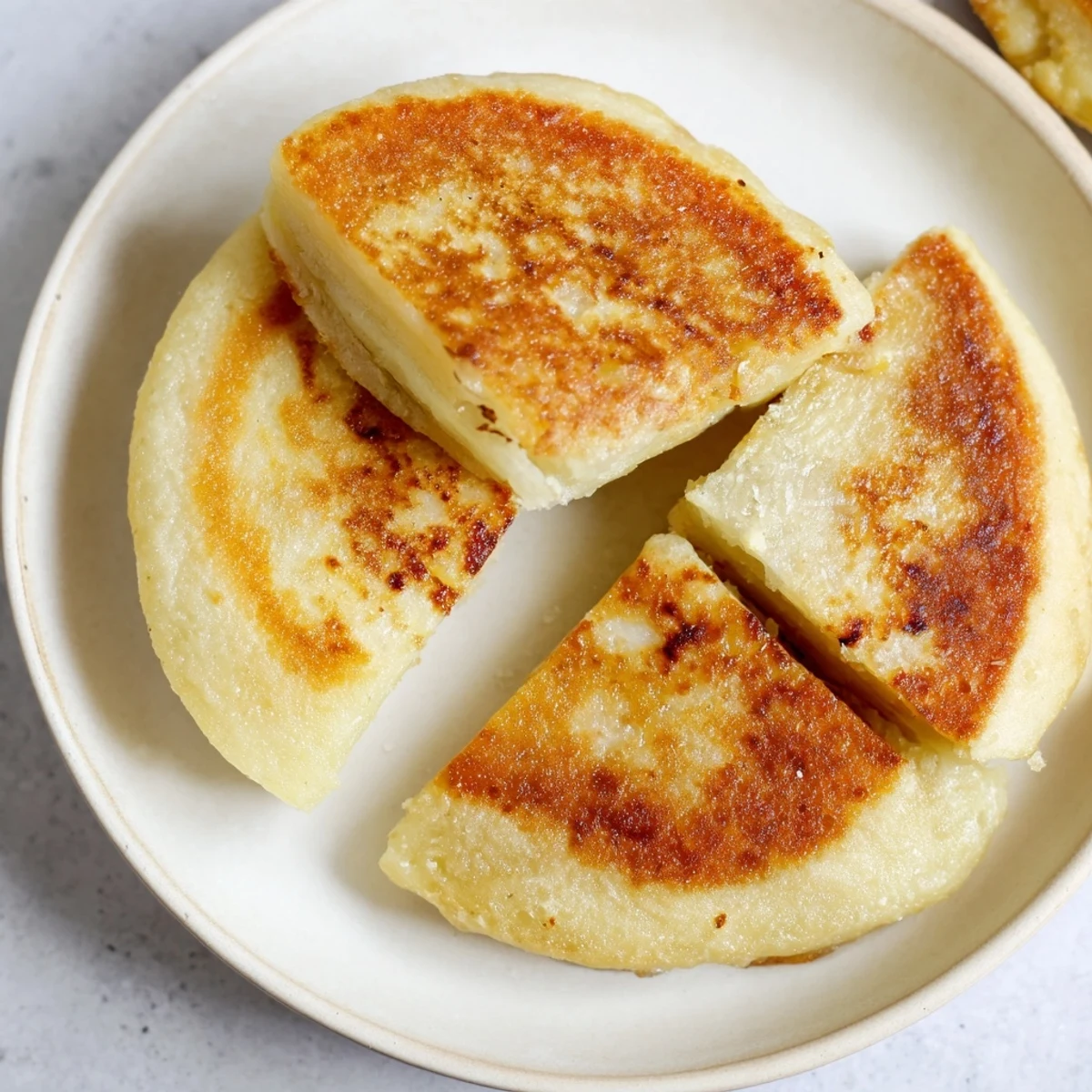 Soft and tender Irish Potato Bread Farls, a traditional side dish ready for a hearty breakfast.