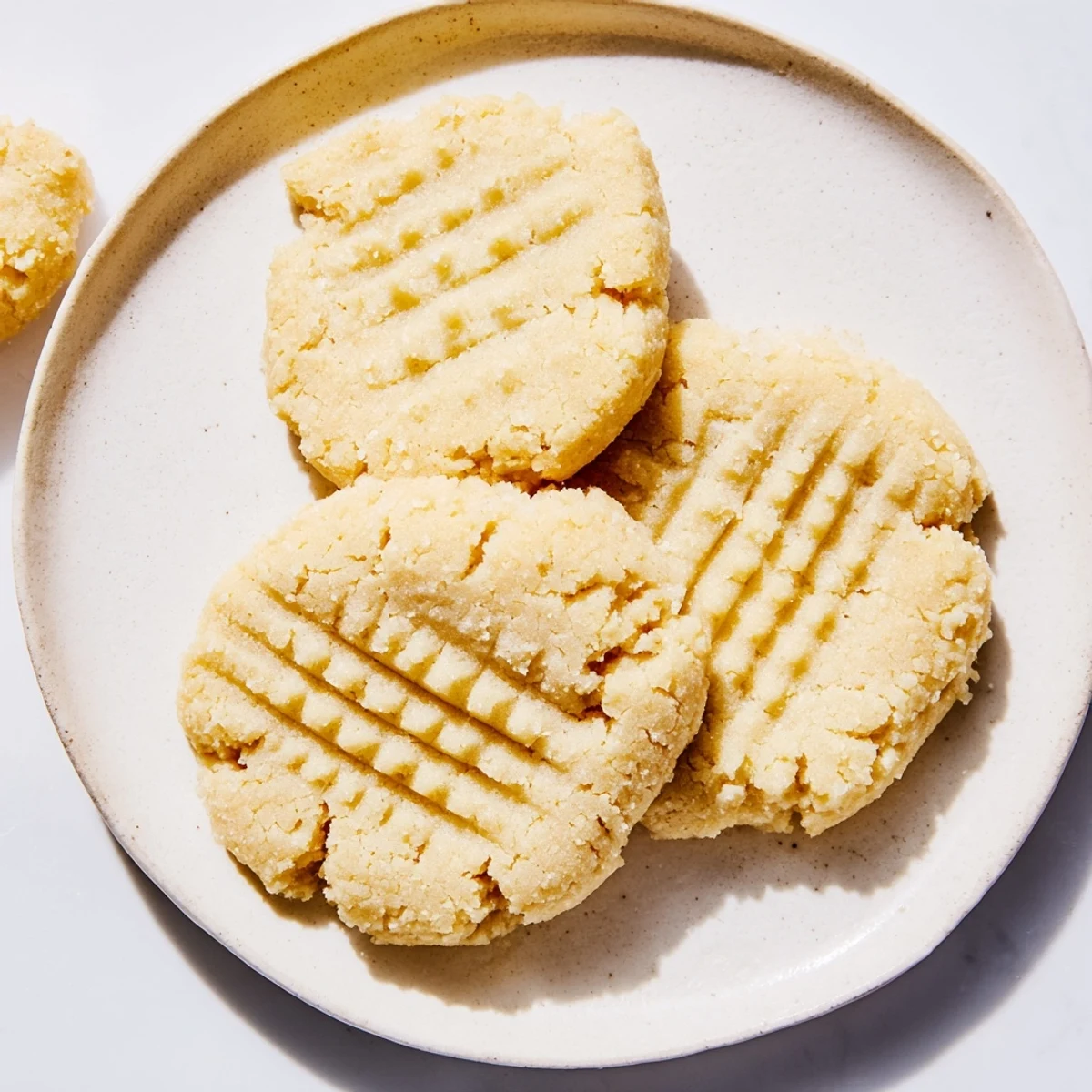 Freshly baked Keto Butter Cookies on a parchment-lined tray, radiating a rich buttery aroma for a keto-friendly dessert.