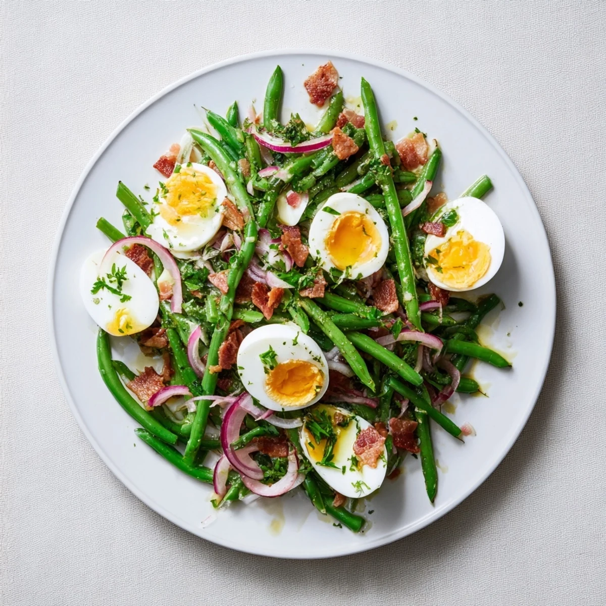 Bright green beans, crispy bacon bits, and creamy quartered eggs tossed in tangy Dijon vinaigrette in the Green Bean, Bacon, and Egg Salad.