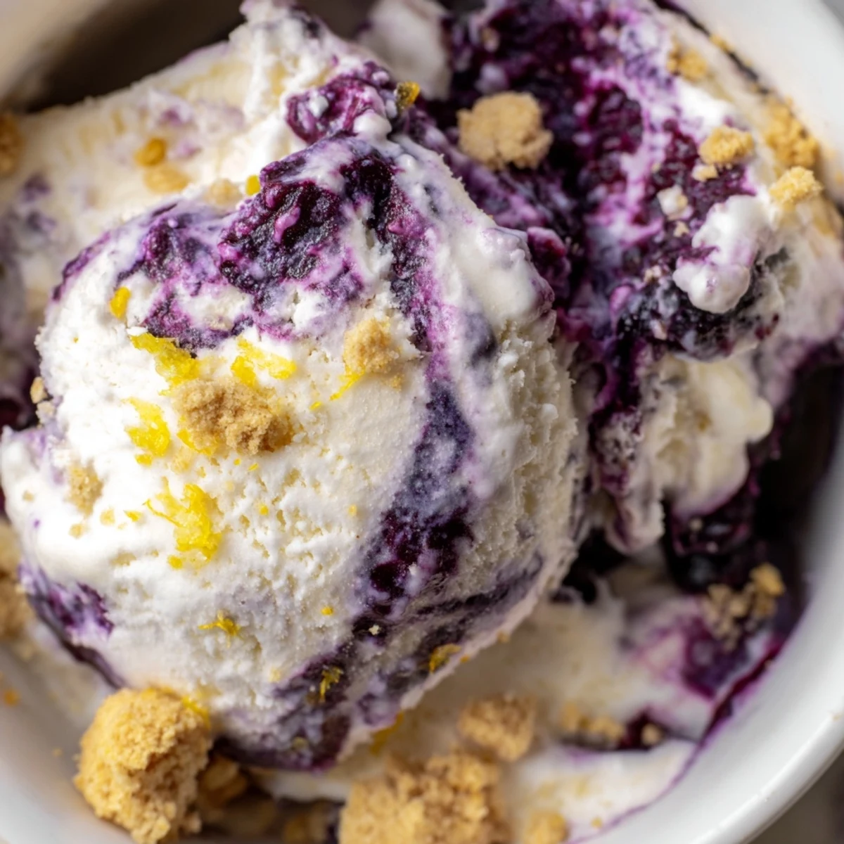 This homemade Lemon Blueberry Cheesecake Ice Cream features a creamy swirl of blueberries and cheesecake flavor.