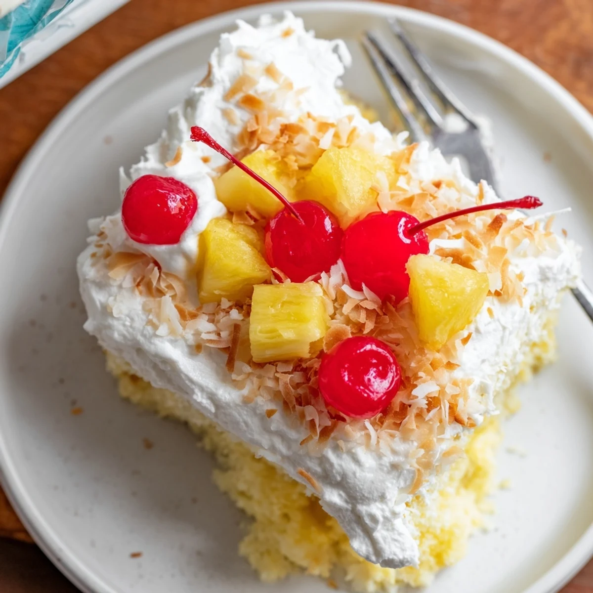 Tropical Hawaiian Poke Cake drizzled with sweetened condensed milk and topped with golden toasted coconut