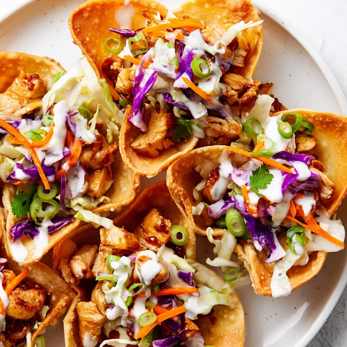 Crispy wonton shell tacos filled with savory glazed chicken and fresh crunchy vegetable slaw mixture
