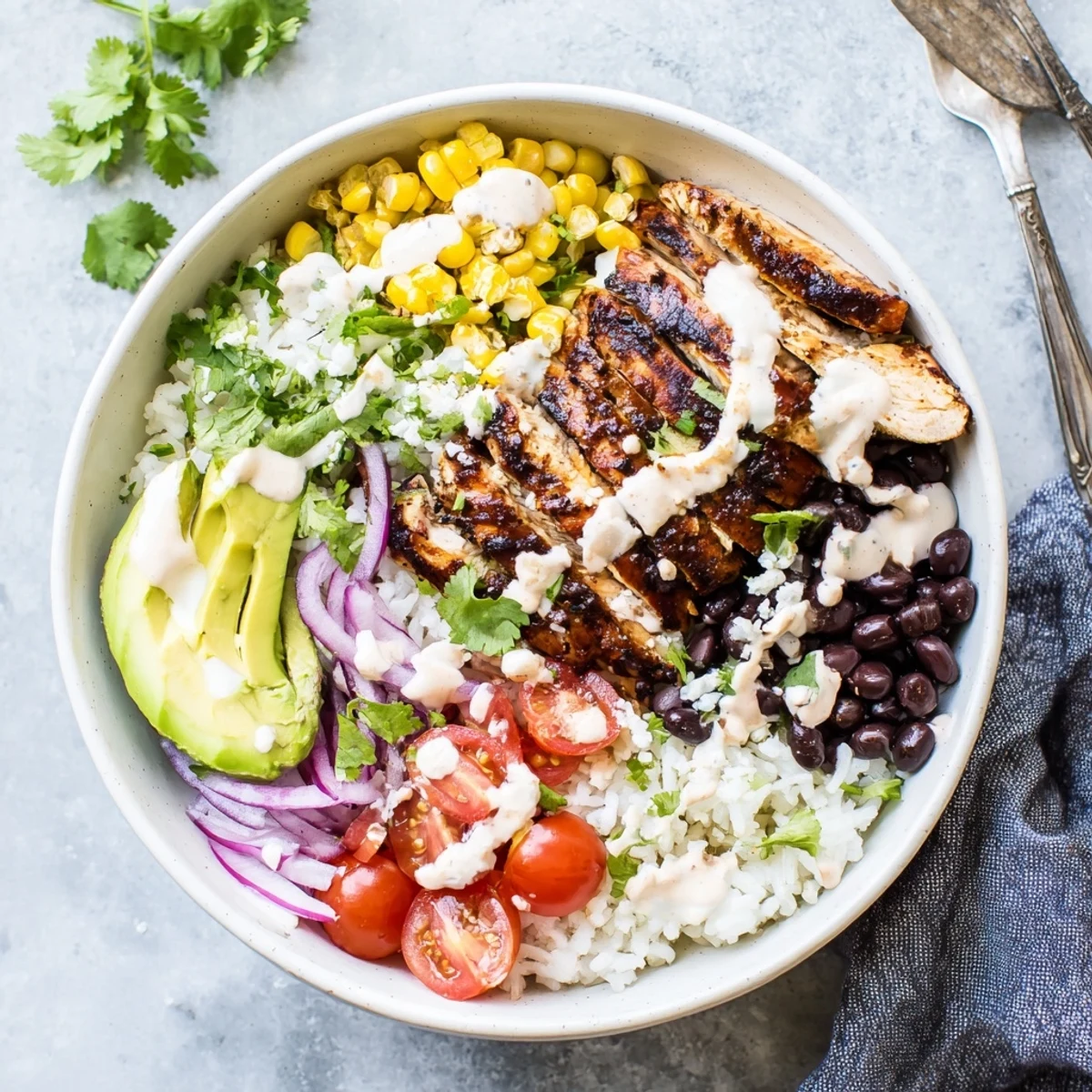 Close-up of ultimate Baja style chicken bowl featuring zesty lime rice, black beans and cotija cheese topping