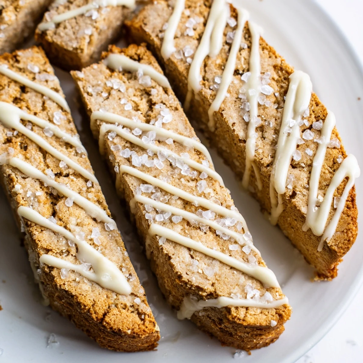 Buttery sugar cookie biscotti logs sliced diagonally and sprinkled with coarse sparkling sugar