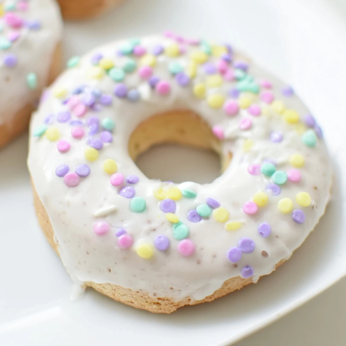 Plate of Italian Easter cookies decorated with vanilla icing and festive sprinkles