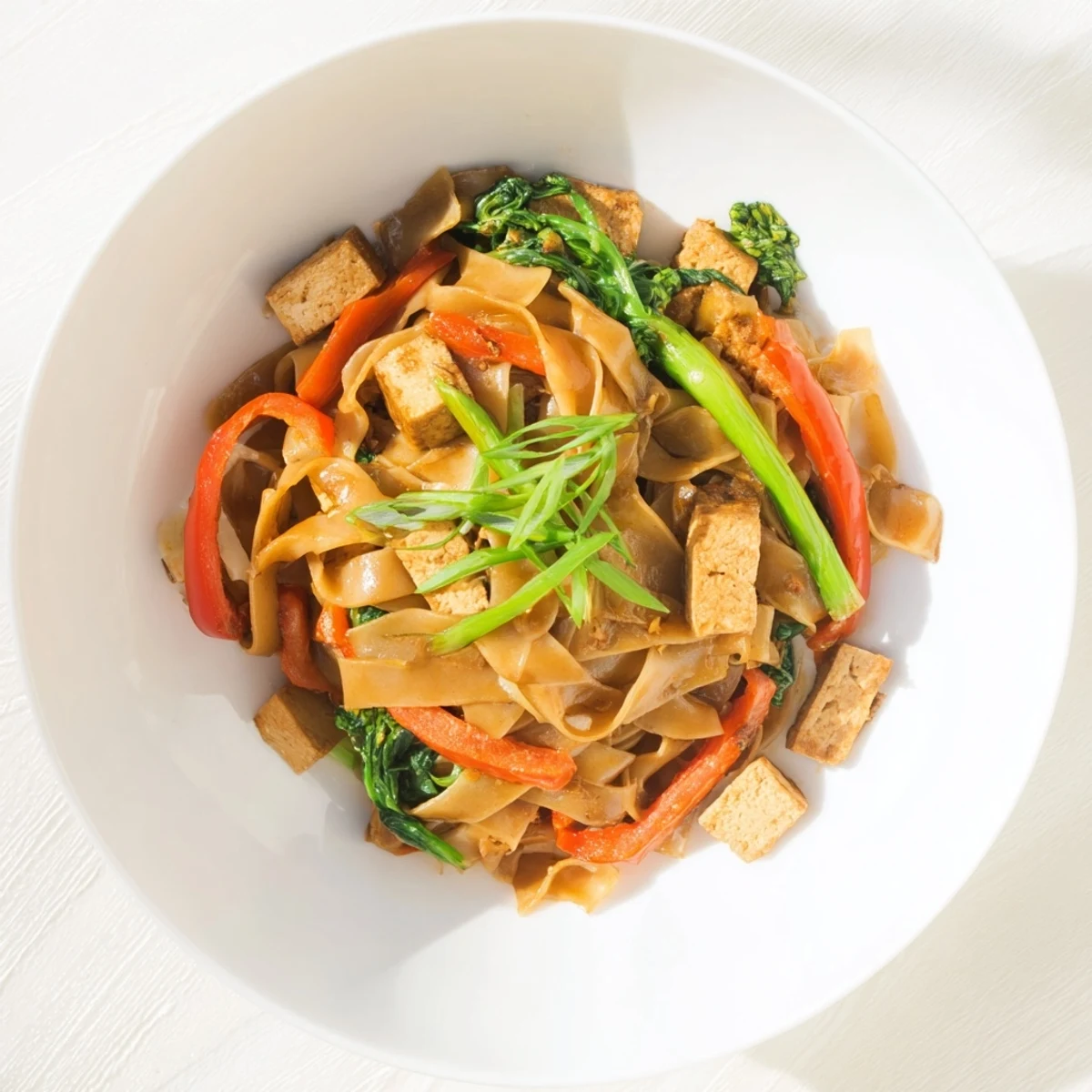Vegan Pad See Ew stir-fried with wide rice noodles, crisp Chinese broccoli, and savory soy sauce