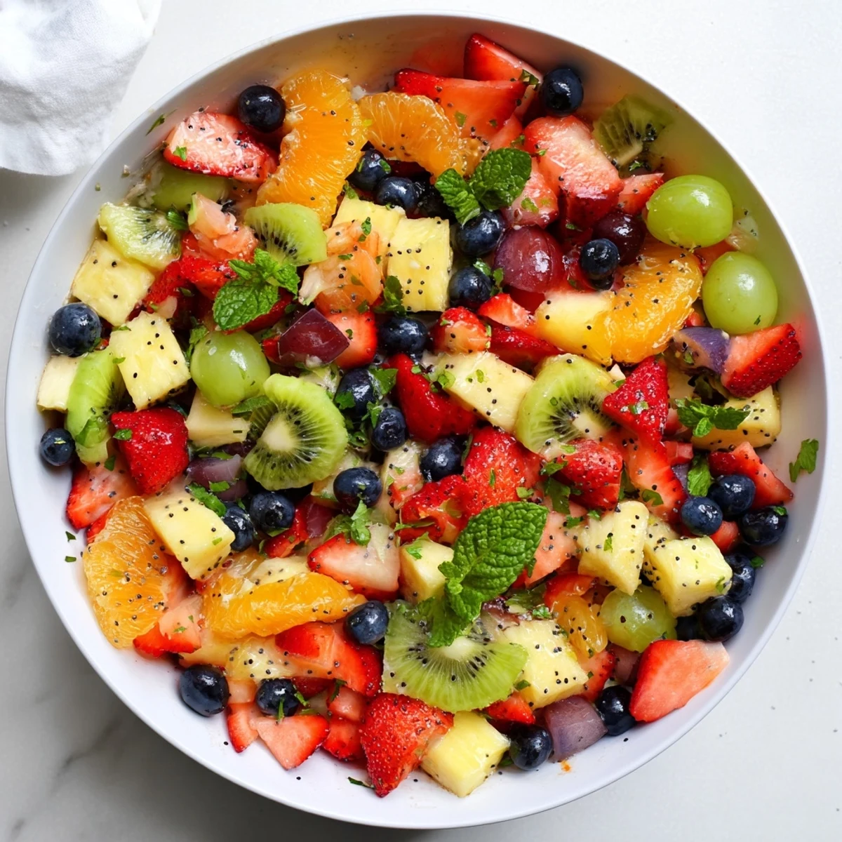 Colorful Easter fruit salad bowl with fresh strawberries, pineapple, kiwi, and mint garnish