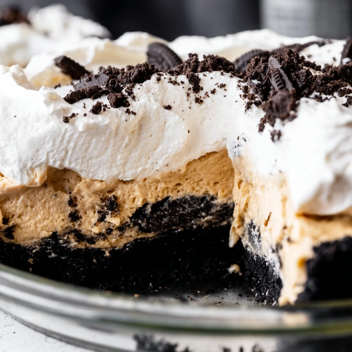 Decadent peanut butter Oreo pie garnished with cookie crumbles on a dessert plate