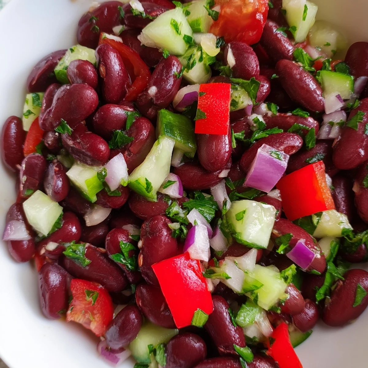 Colorful kidney bean salad in a rustic bowl with crisp vegetables and fresh herbs