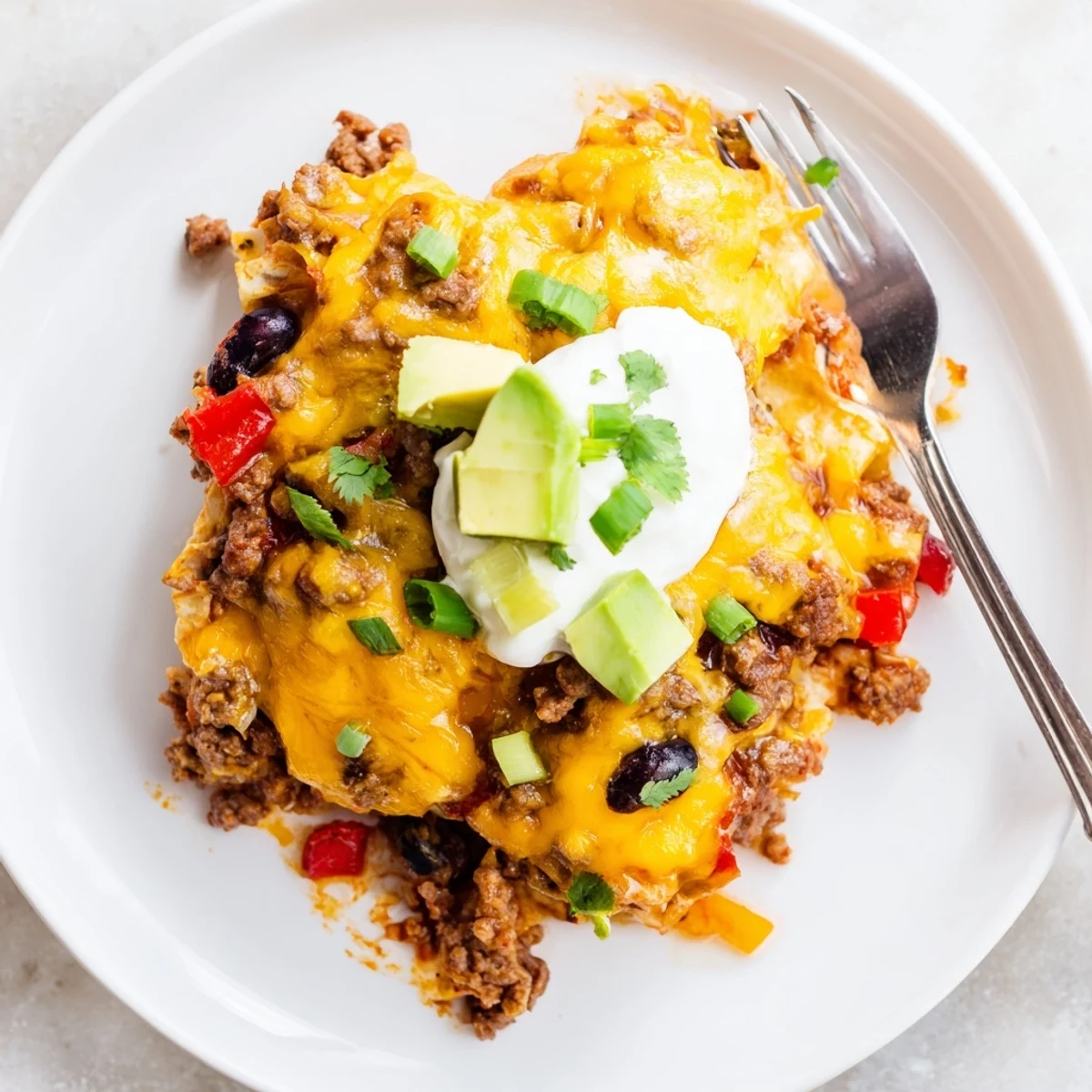 Beef Skillet Enchiladas bubbling in a golden cheese skillet, garnished with cilantro.