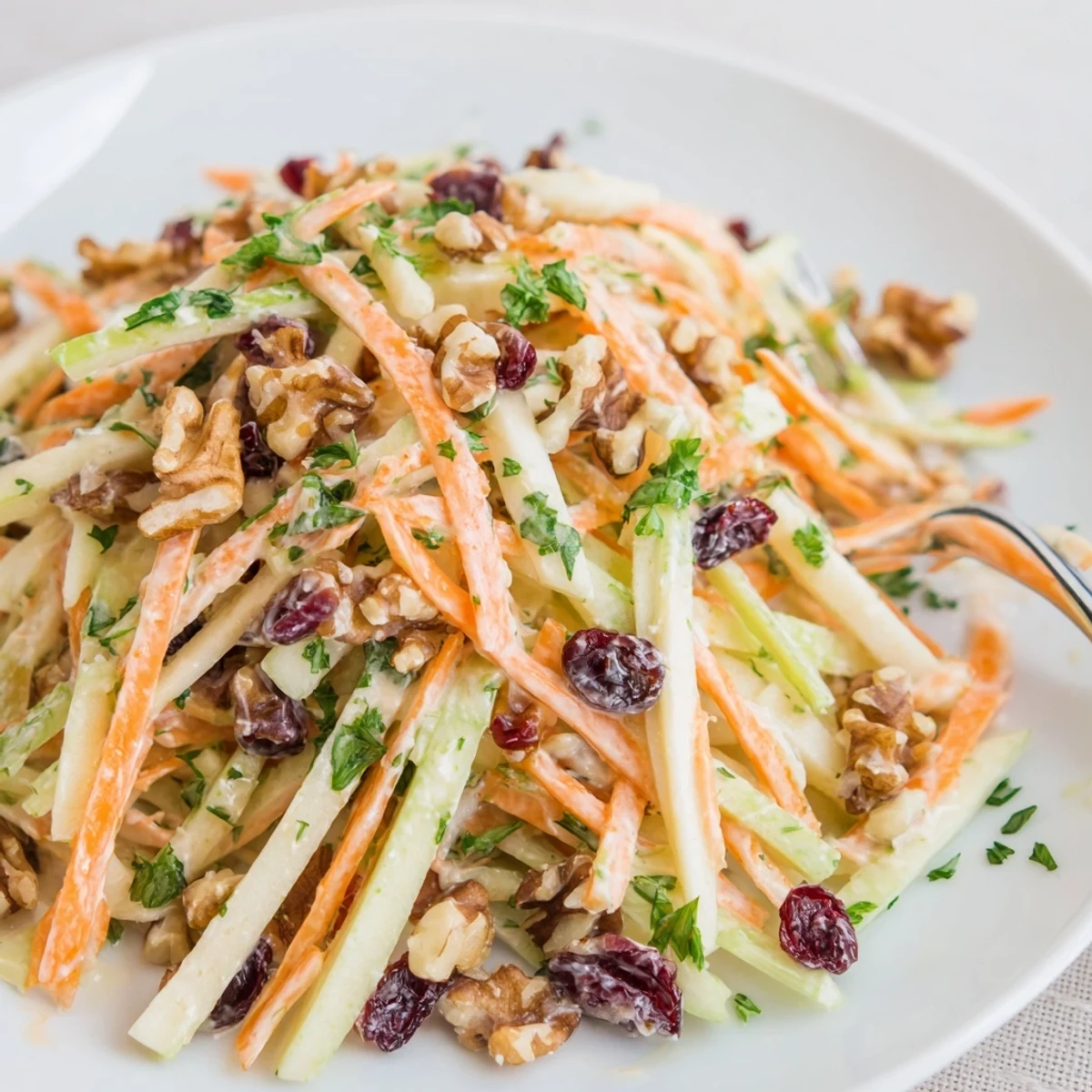 Crunchy Apple Carrot Salad With Creamy Citrus Dressing tossed and ready, chilled serving
