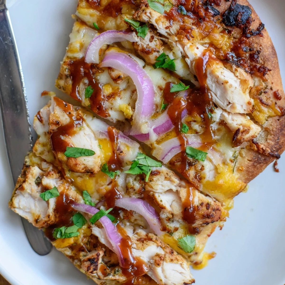 Grilled BBQ Chicken Pizza Recipe on a grill with bubbly cheese and charred edges