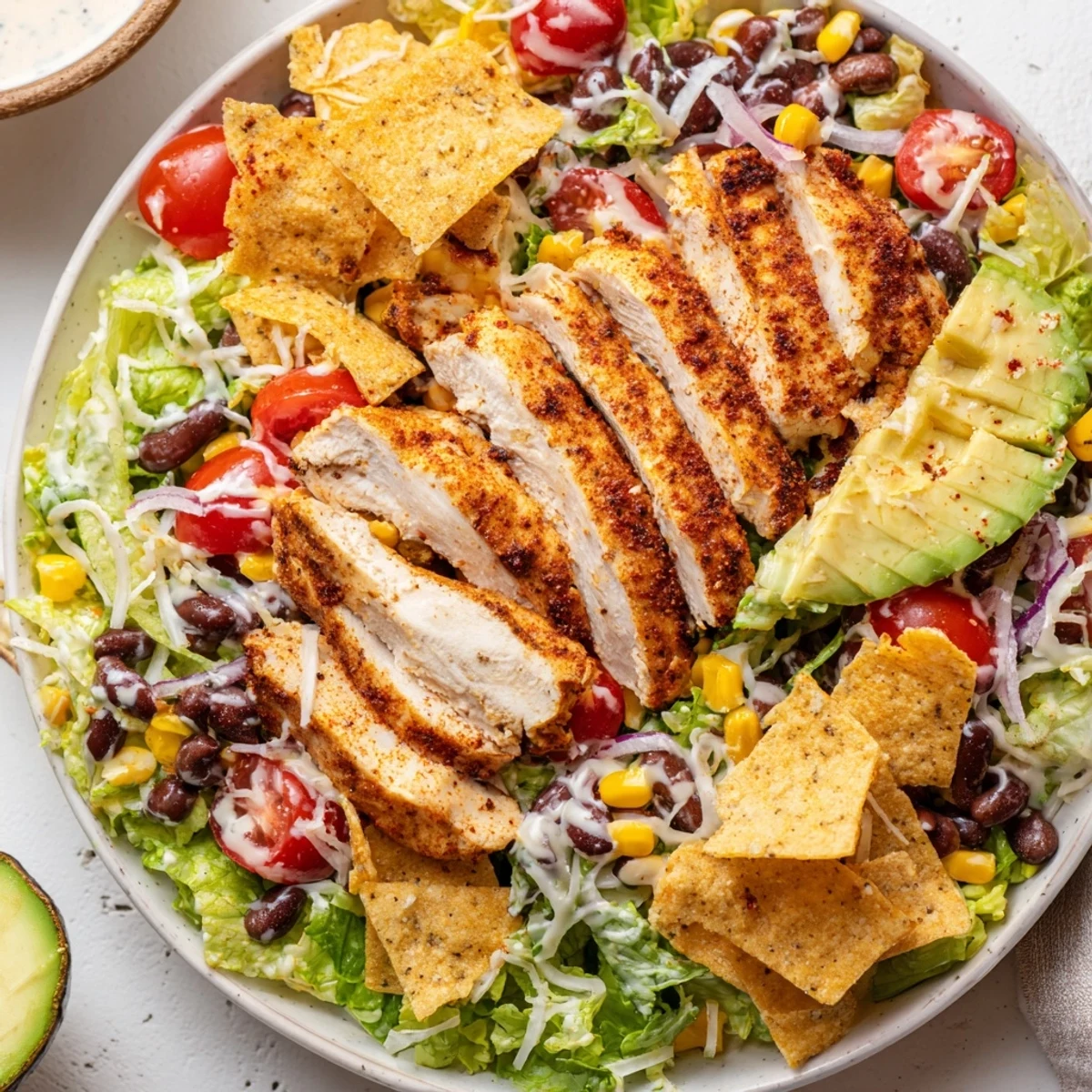 Bowl of Spicy Southwest Salad With Spicy Ranch Dressing topped with crunchy tortilla strips