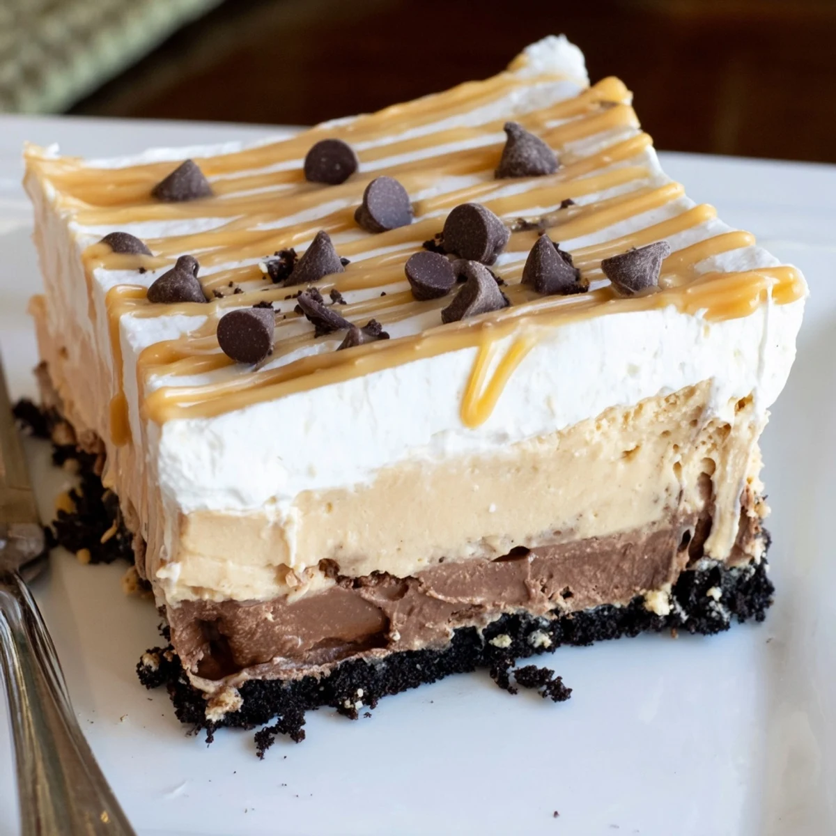 Creamy peanut butter layered delight with rich chocolate pudding in a glass dish