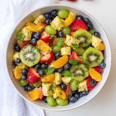 Refreshing Easter fruit salad displaying vibrant spring fruits in honey lime dressing